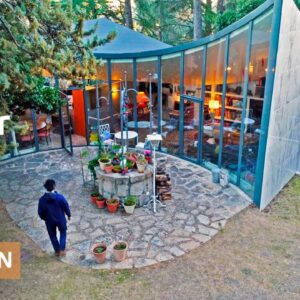 Drained water tank becomes curved, earthship-like sunken home